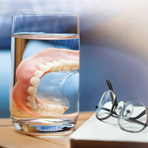 Denture in a cup