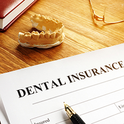 Dental insurance plan policy and glasses.
